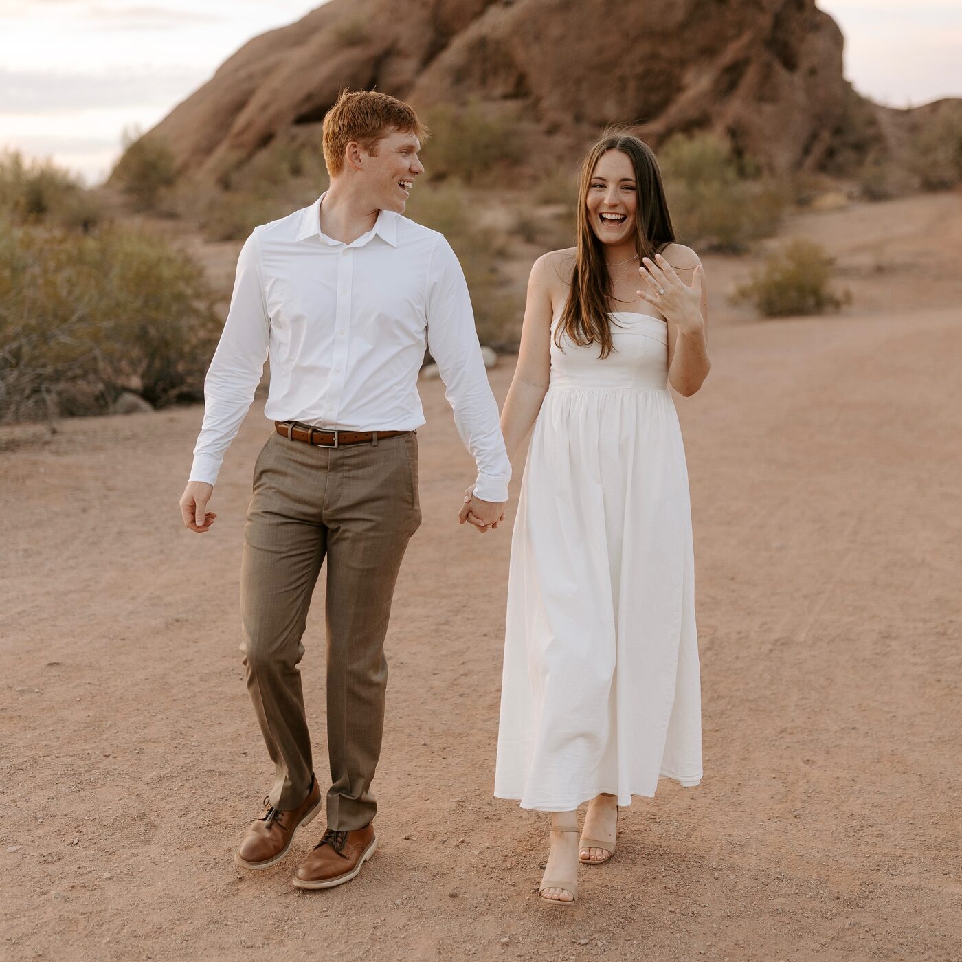 Denae and Kyle walking together in the desert